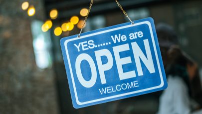 open sign broad through the glass of window at coffee shop open sign broad through the glass of window at coffee shop