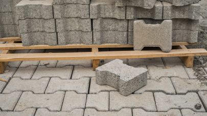 Paving slabs stacked on a pallet, road repair process, close-up, selective focus on tiles, seasonal reconstruction of pavement in walking paths in parks Paving slabs stacked on a pallet, road repair process, close-up, selective focus on tiles, seasonal reconstruction of pavement in walking paths in parks